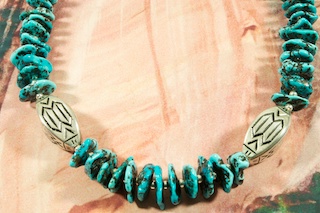 Stunning Necklace featuring Genuine Sleeping Beauty Turquoise with Sterling Silver Accents Beads. Two Beautiful Sterling Silver Hand Stamped Medallions. Created by Santo Domingo Artist Carol Pacheco. The Santo Domingo Pueblo is in New Mexico, near Santa Fe